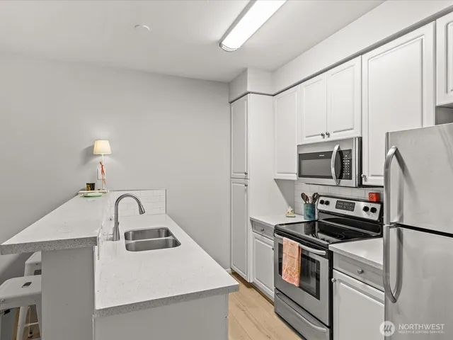 a kitchen with a sink a stove and refrigerator