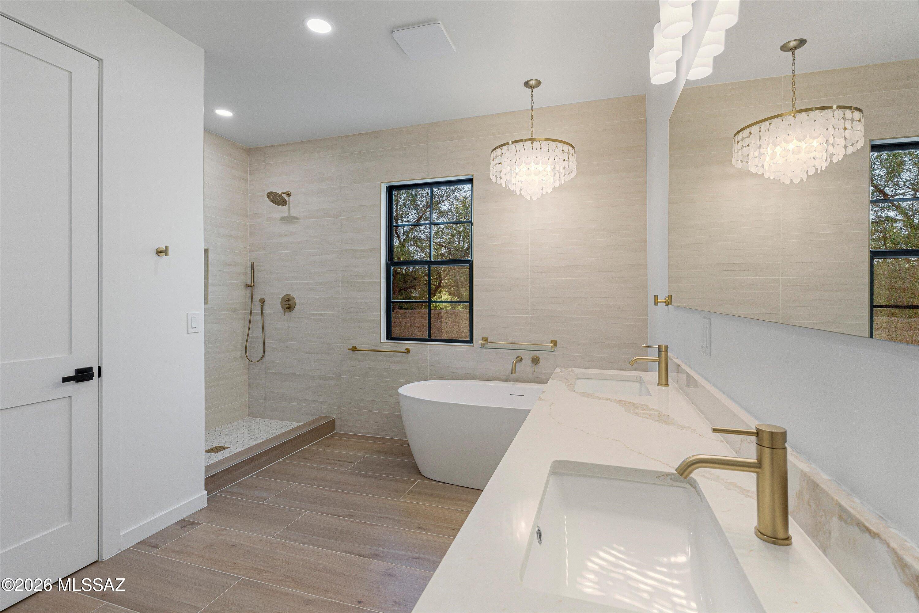 5259 East Fort Lowell Road Tucson, AZ 85712 - Photo 25 of 50 a spacious bathroom with a tub sink and mirror