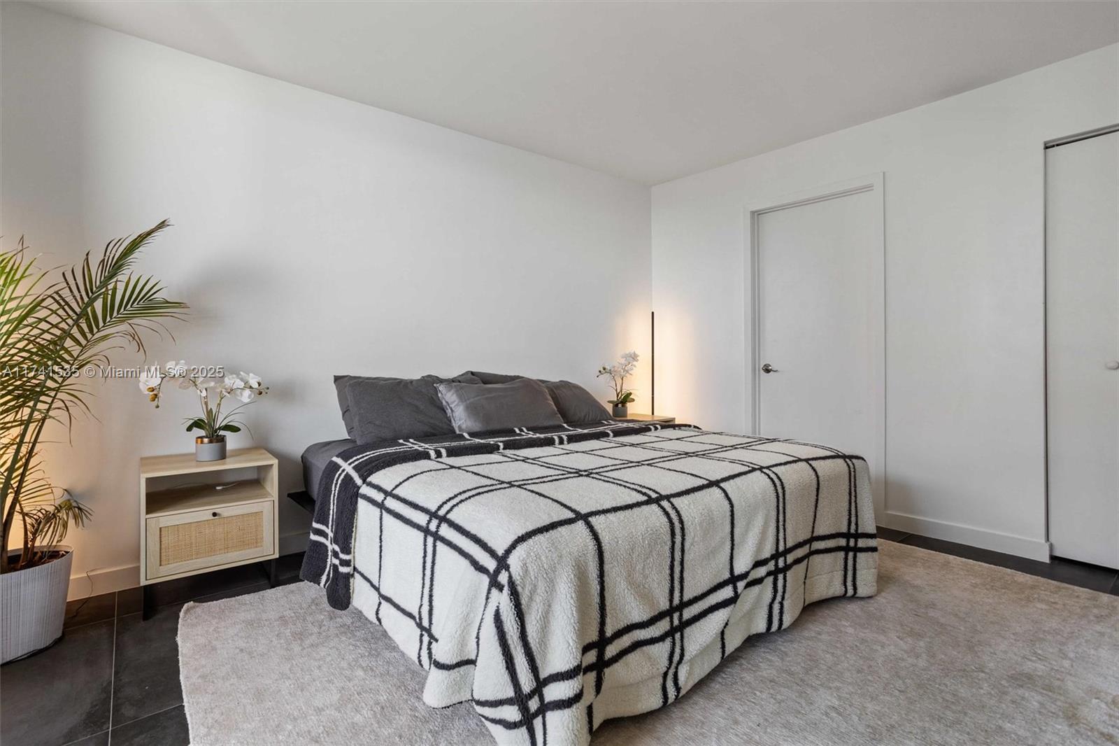 540 Brickell Key Drive, Unit 1519 Miami, FL 33131 - Photo 19 of 48 a bedroom with a bed and a table