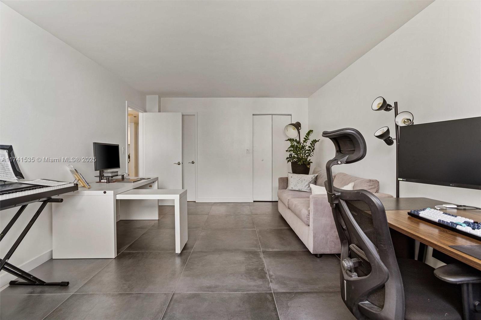 540 Brickell Key Drive, Unit 1519 Miami, FL 33131 - Photo 28 of 48 a living room with furniture a flat screen tv and a fireplace