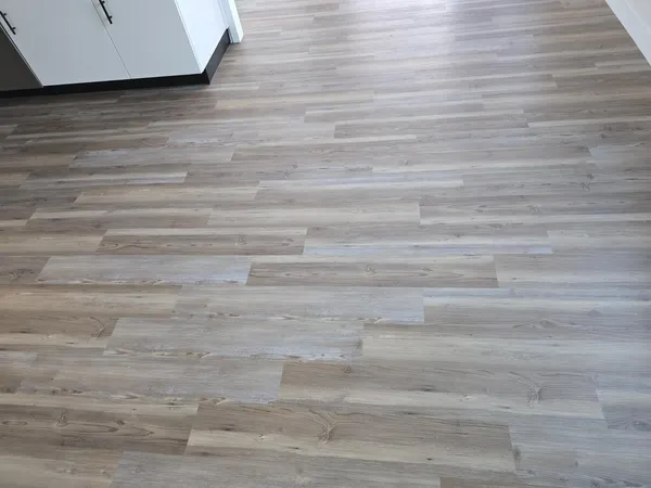 a view of wooden floor and windows in a room