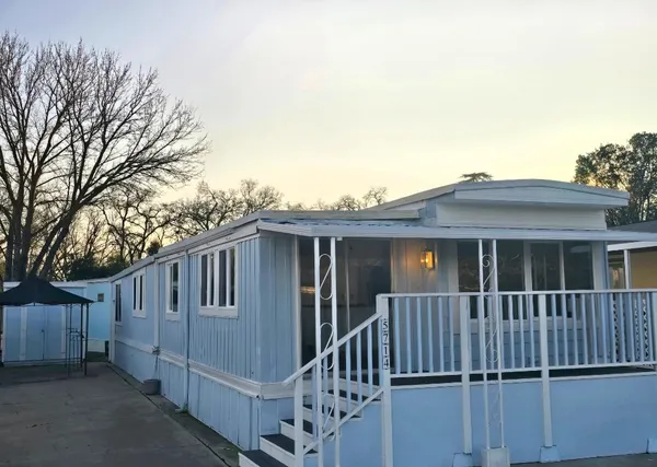 a view of a house with wooden fence