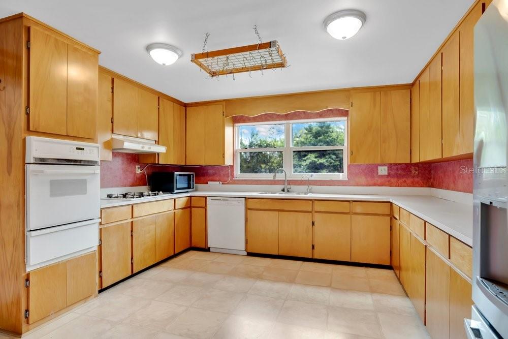 5137 Mt Plymouth Road Apopka, FL 32712 - Photo 11 of 58 a kitchen with stainless steel appliances granite countertop a sink a stove and a refrigerator