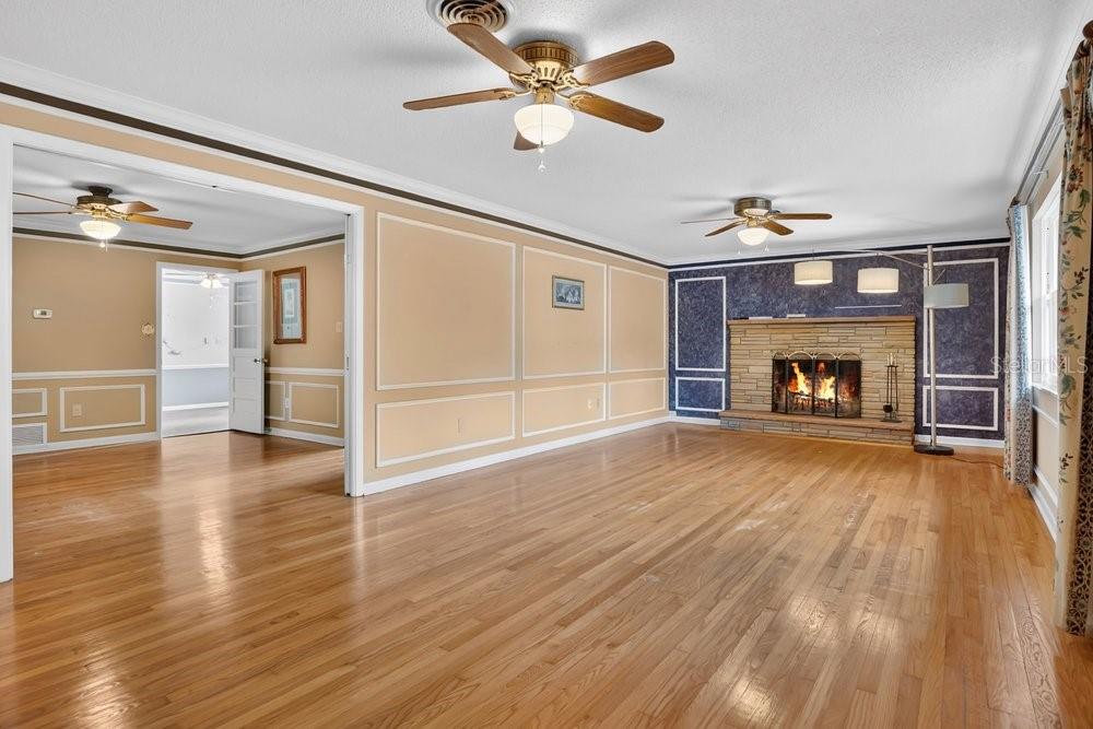 5137 Mt Plymouth Road Apopka, FL 32712 - Photo 14 of 58 a view of empty room with wooden floor and fireplace