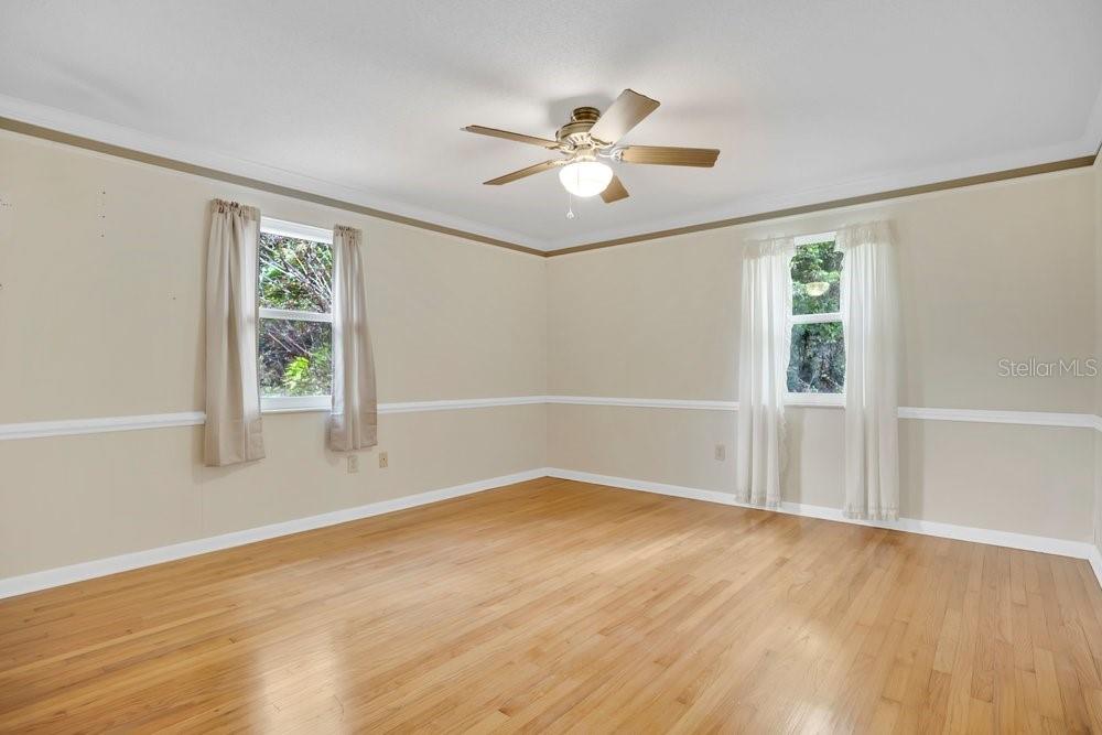 5137 Mt Plymouth Road Apopka, FL 32712 - Photo 18 of 58 a view of an empty room with wooden floor and a window