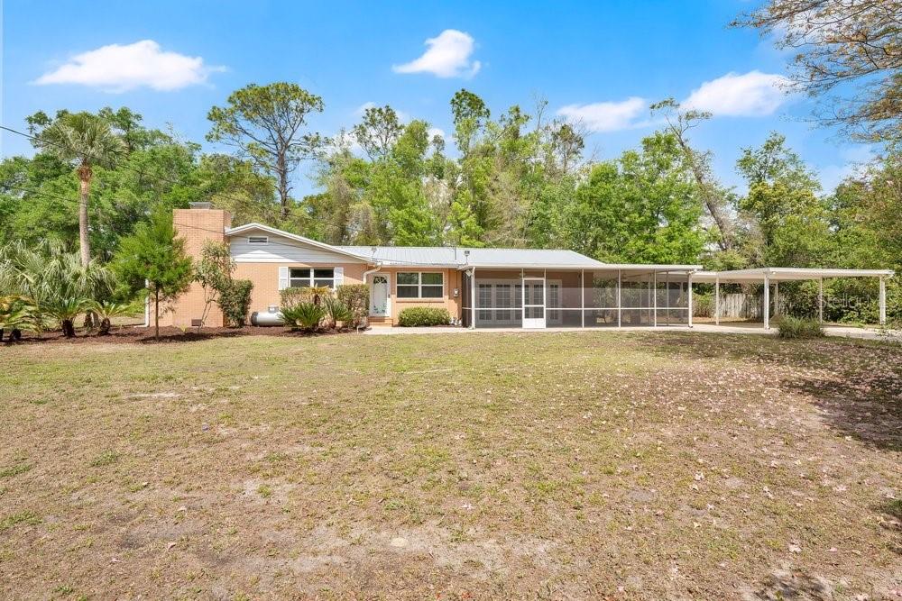 5137 Mt Plymouth Road Apopka, FL 32712 - Photo 2 of 58 a house with trees in the background