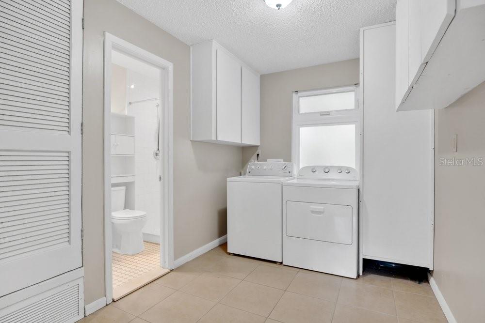5137 Mt Plymouth Road Apopka, FL 32712 - Photo 24 of 58 a utility room with cabinets washer and dryer