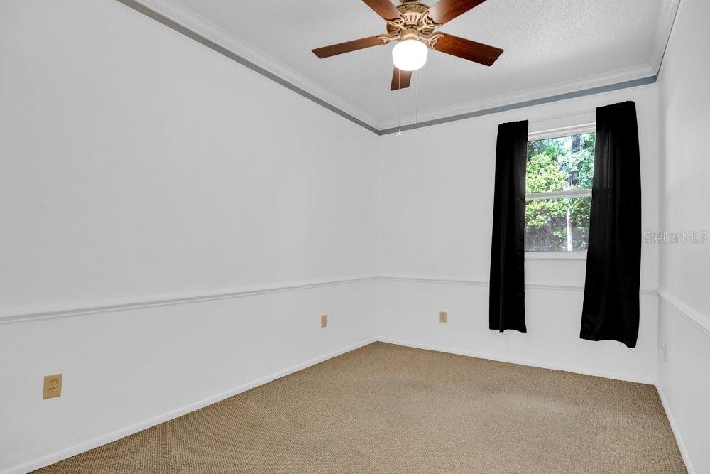 5137 Mt Plymouth Road Apopka, FL 32712 - Photo 28 of 58 an empty room with a window and a ceiling fan