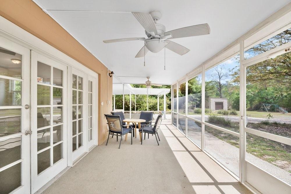 5137 Mt Plymouth Road Apopka, FL 32712 - Photo 32 of 58 a view of a dining room with furniture large windows and wooden floor