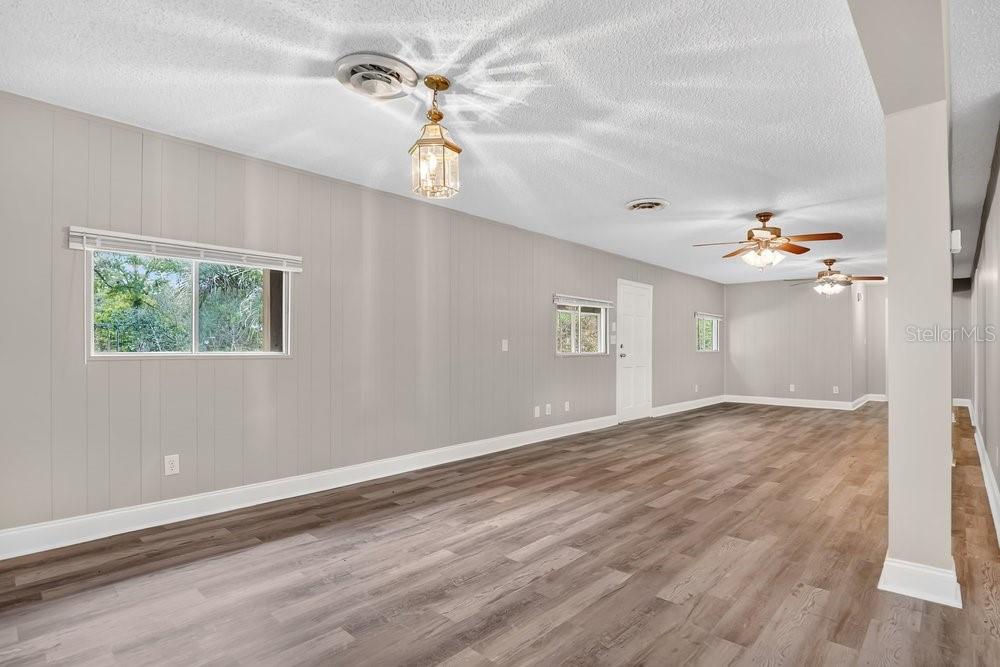 5137 Mt Plymouth Road Apopka, FL 32712 - Photo 41 of 58 a view of an empty room with window and wooden floor