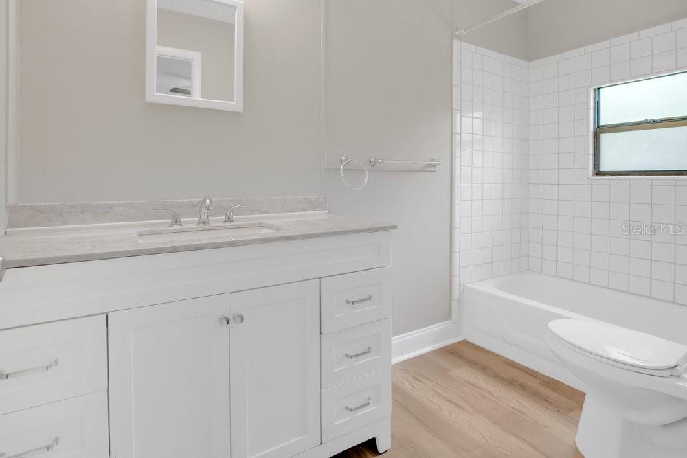 5137 Mt Plymouth Road Apopka, FL 32712 - Photo 44 of 58 a bathroom with a sink a toilet and bathtub