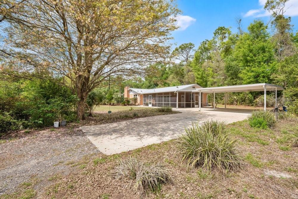 5137 Mt Plymouth Road Apopka, FL 32712 - Photo 5 of 58 a house that has a big yard with large trees