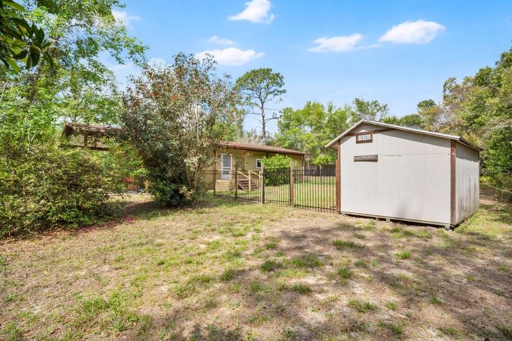 5137 Mt Plymouth Road Apopka, FL 32712 - Photo 54 of 58 a view of a house with a yard and potted plants