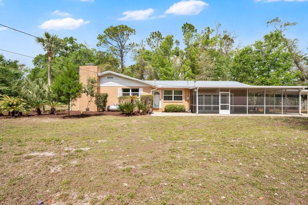 5137 Mt Plymouth Road Apopka, FL 32712 - Photo 7 of 58 a front view of a house with a garden