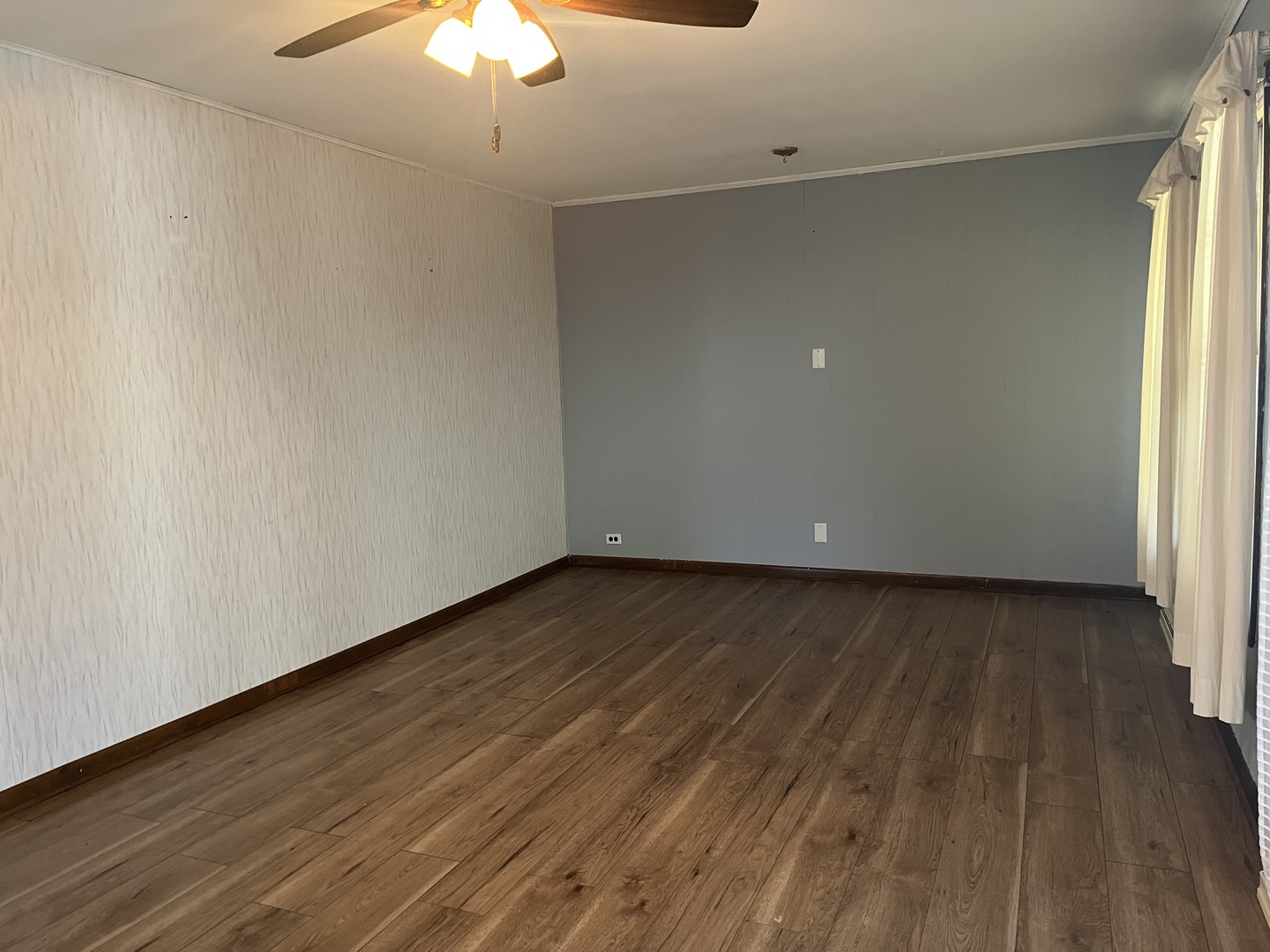 112 Chicago Road, Unit 1 Oswego, IL 60543 - Photo 12 of 29 a view of an empty room with wooden floor and a window
