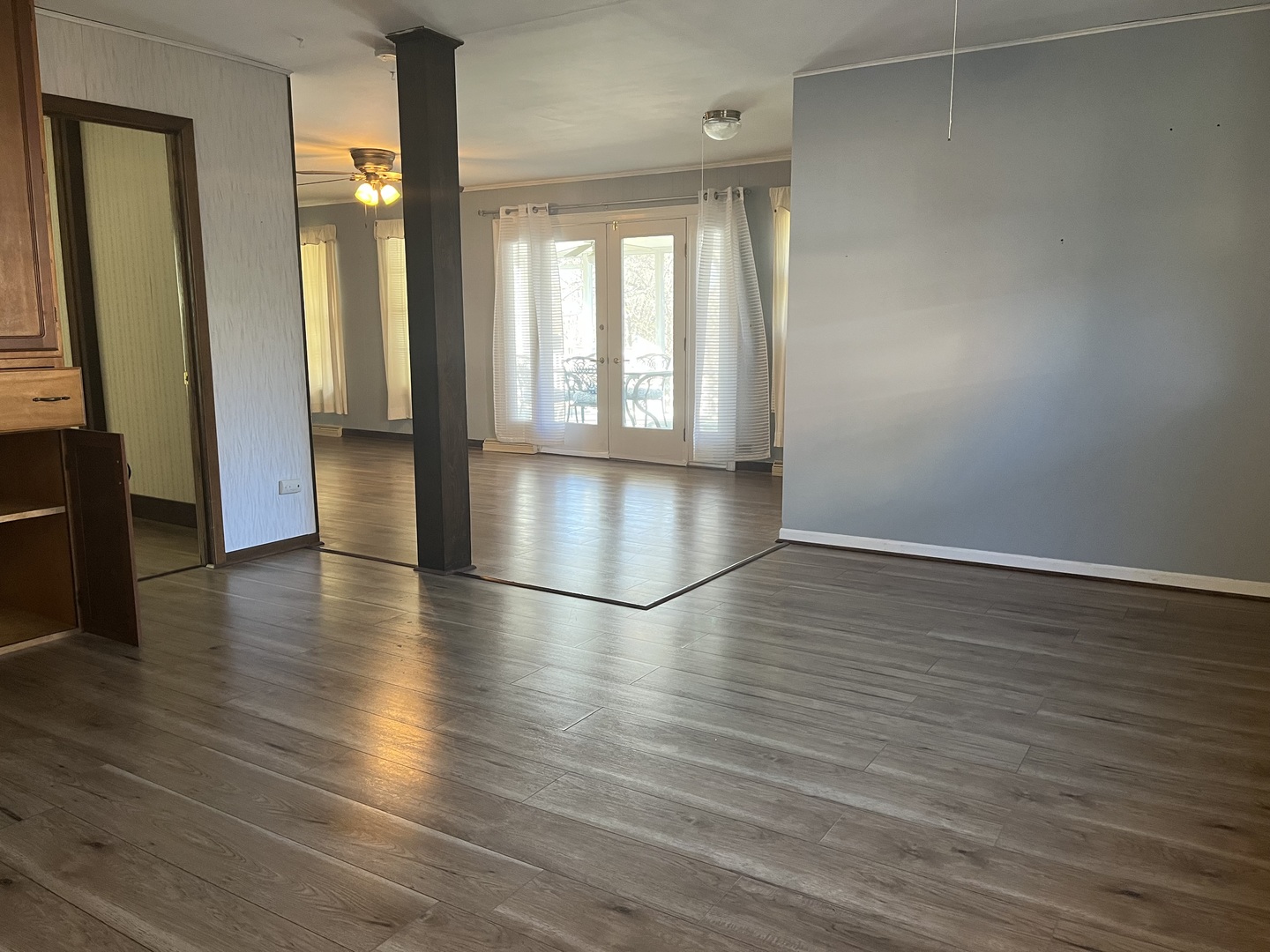 112 Chicago Road, Unit 1 Oswego, IL 60543 - Photo 13 of 29 an empty room with wooden floor and windows