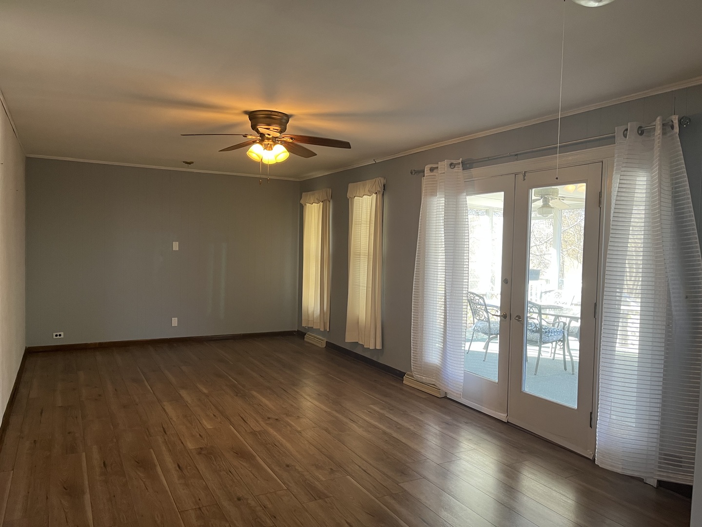 112 Chicago Road, Unit 1 Oswego, IL 60543 - Photo 14 of 29 a view of empty room with wooden floor and fan