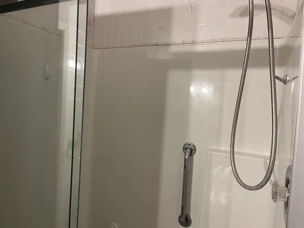 a bathroom with a glass shower door