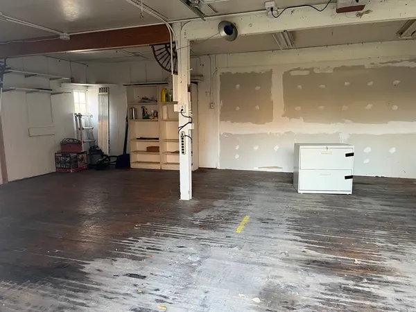 a view of a room with wooden floor