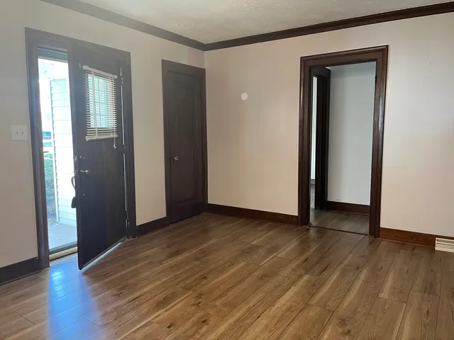 an empty room with wooden floor and closet