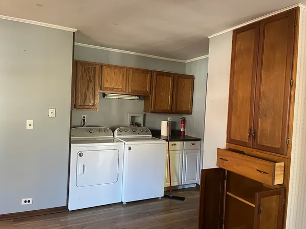 a kitchen with a refrigerator stove and wooden cabinets
