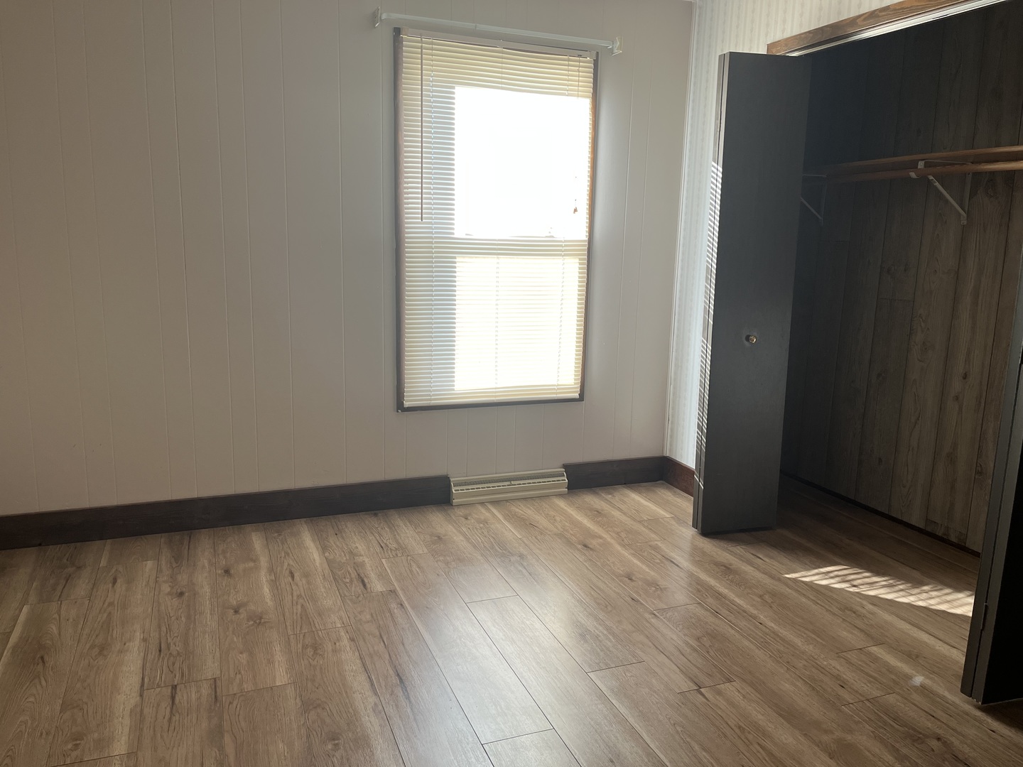 112 Chicago Road, Unit 1 Oswego, IL 60543 - Photo 9 of 29 an empty room with wooden floor and windows