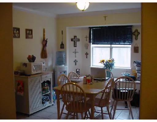 a view of a dining room with furniture and window