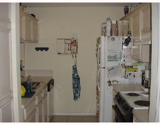 a bathroom with a refrigerator and window