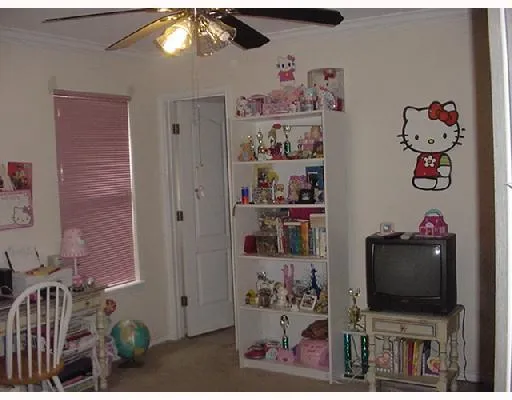 a living room with furniture a flat screen tv and a wall