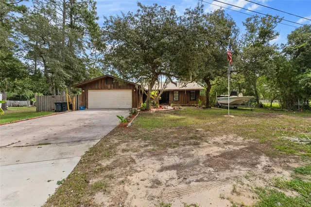 a view of a house with a yard and sitting area