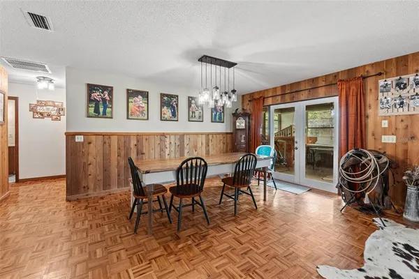 a dining room with furniture and wooden floor