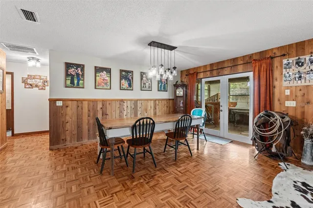 a dining room with furniture and wooden floor