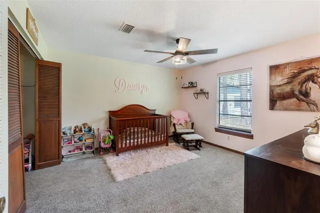 a spacious bedroom with a bed and a ceiling fan