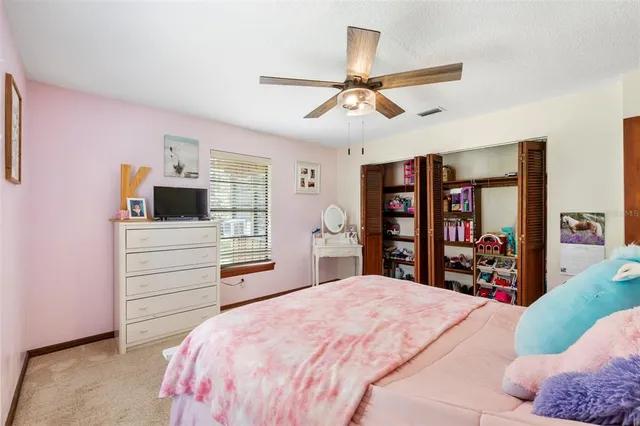 an aerial view of a house with a yard and trees