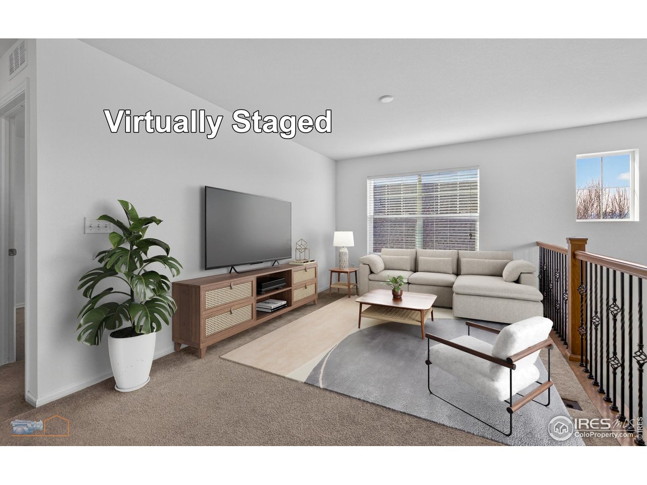 1435 Rustic Drive Longmont, CO 80504 - Photo 23 of 45 a living room with furniture and a flat screen tv