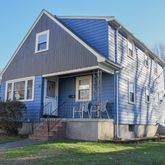 a front view of house with yard and outdoor seating