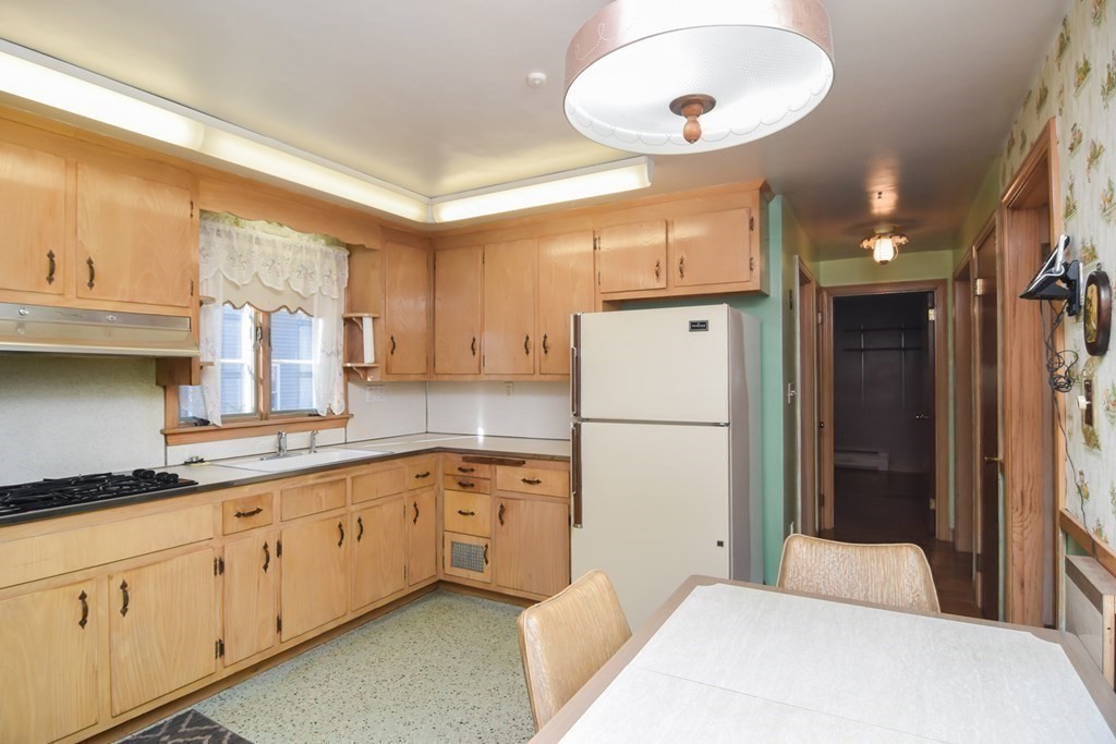 86 Clark Street Dedham, MA 02026 - Photo 16 of 28 a kitchen with white cabinets and white appliances