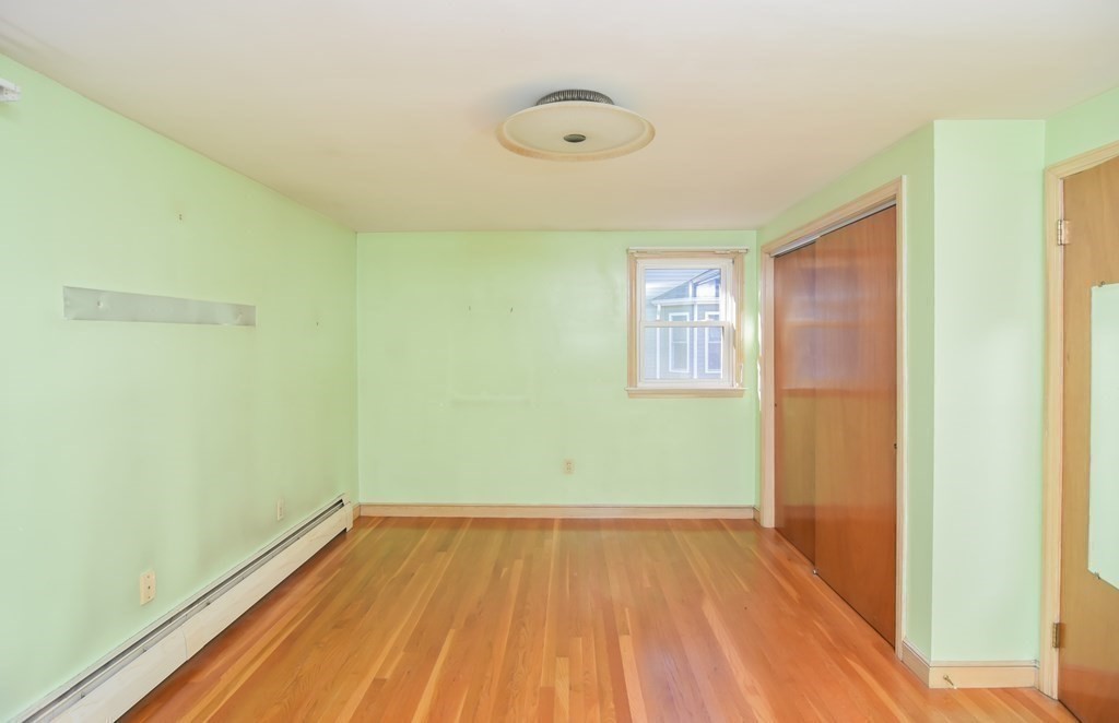 86 Clark Street Dedham, MA 02026 - Photo 20 of 28 a view of a room with wooden floor and a ceiling fan