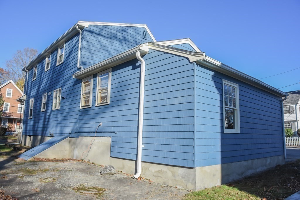 86 Clark Street Dedham, MA 02026 - Photo 6 of 28 a front view of a house with a garden