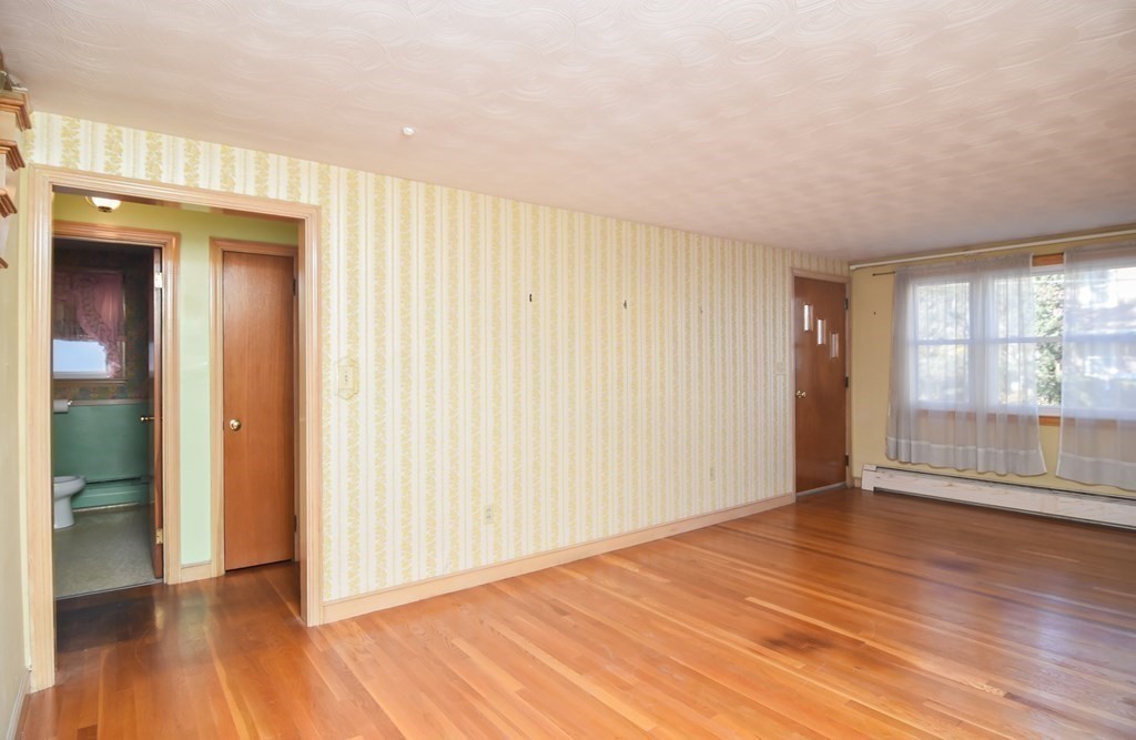 86 Clark Street Dedham, MA 02026 - Photo 7 of 28 wooden floor in an empty room with a window