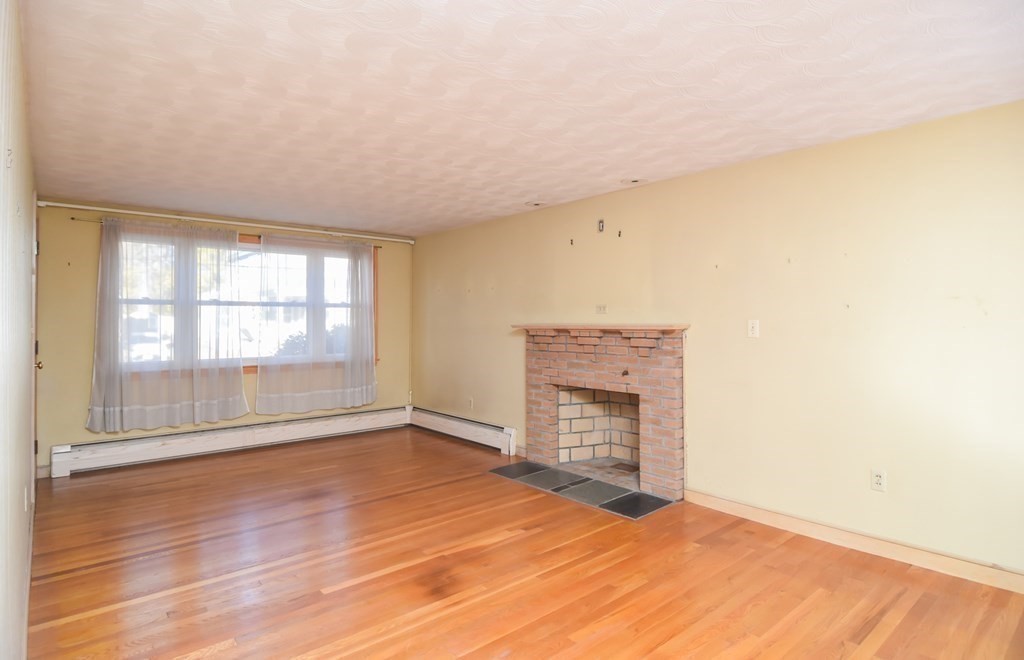 86 Clark Street Dedham, MA 02026 - Photo 10 of 28 a view of empty room with wooden floor and fan