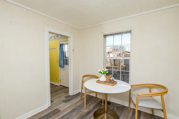 a view of a room with furniture and wooden floor