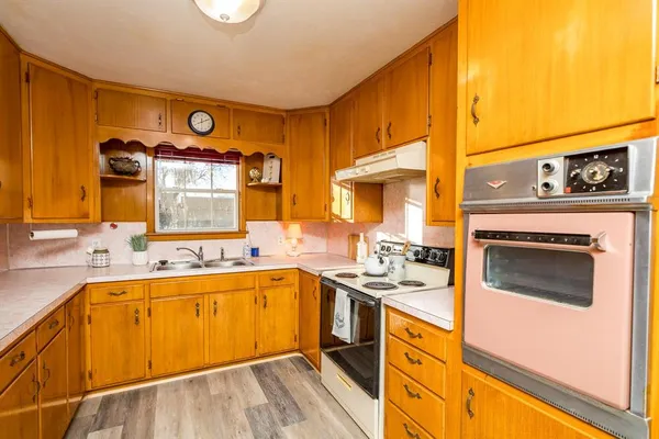 a kitchen with a sink stove and cabinets