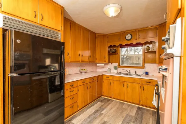 a kitchen with a sink cabinets and appliances