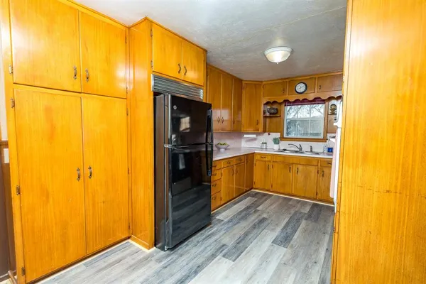 a kitchen with stainless steel appliances a refrigerator and a stove