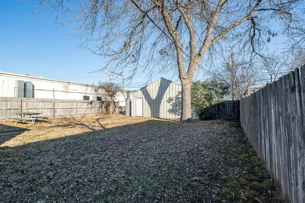 a view of a backyard with large trees
