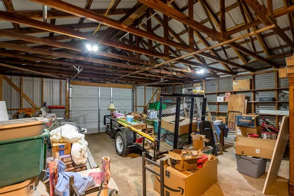 a view of a storage room with water heater and racks