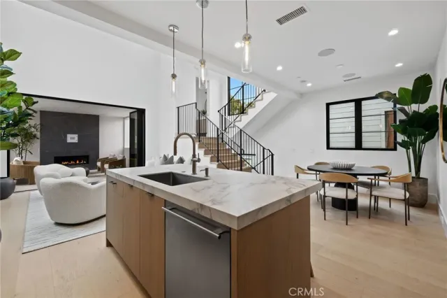 a kitchen with a table chairs and a living room