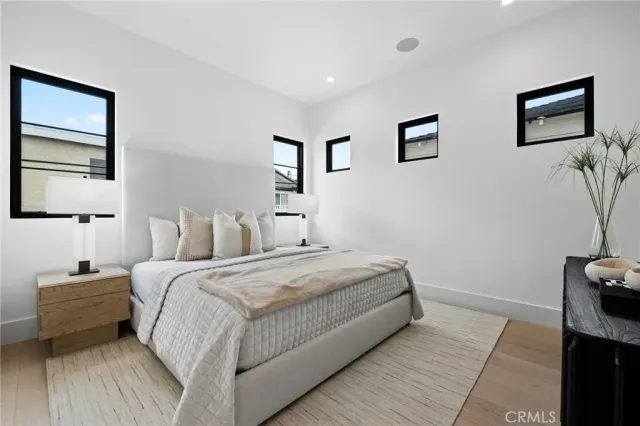 a bedroom with bed and a night stand