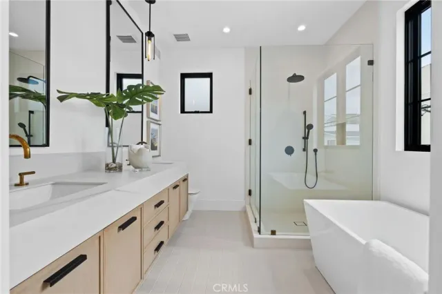 a bathroom with a double vanity sink and a bathtub